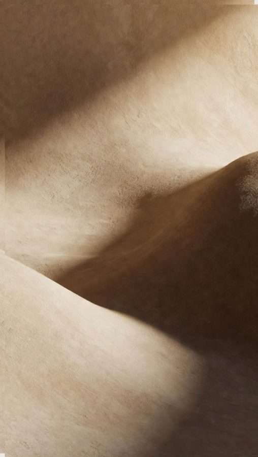 Close view of a curved stone surface, the polished edge falling away into deep shadow