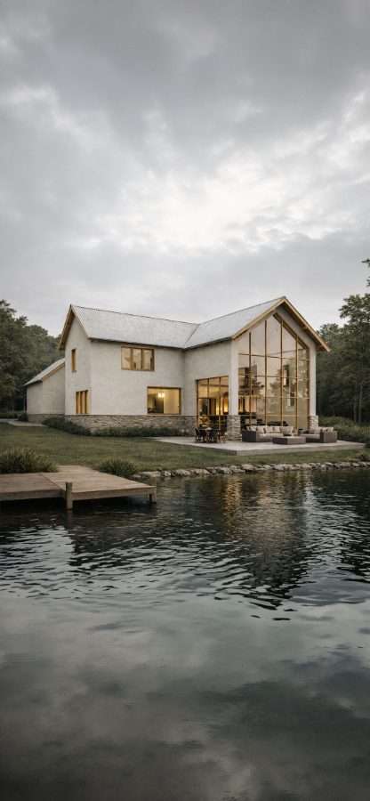 Artist impression — the Vista House seen further back across the lake at dusk, the glazed gable lit from within and the roofline reflected in still water