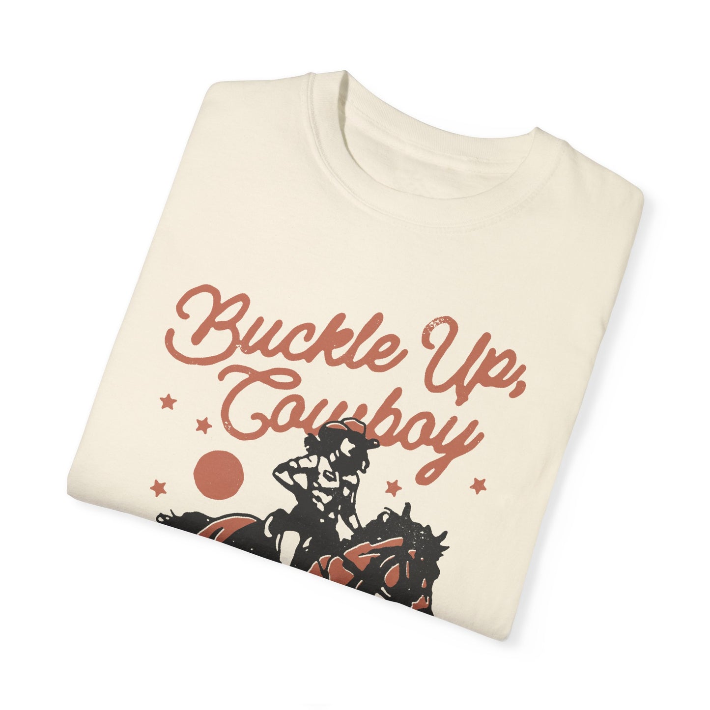 This Shirt Says "Buckle Up Cowboy, Life's a Rodeo" It's a Ivory Cowgirl Graphic T-Shirt With A Girl Riding A Horse