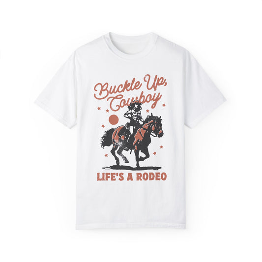 This Shirt Says "Buckle Up Cowboy, Life's a Rodeo" It's a White Cowgirl Graphic T-Shirt With A Girl Riding A Horse